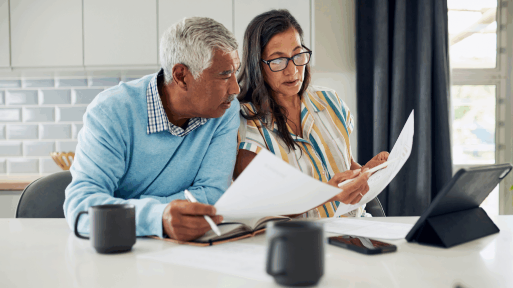 Elderly couple reviewing their application for senior tax freeze