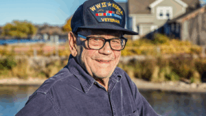 Elderly veteran smiles while wearing his hat