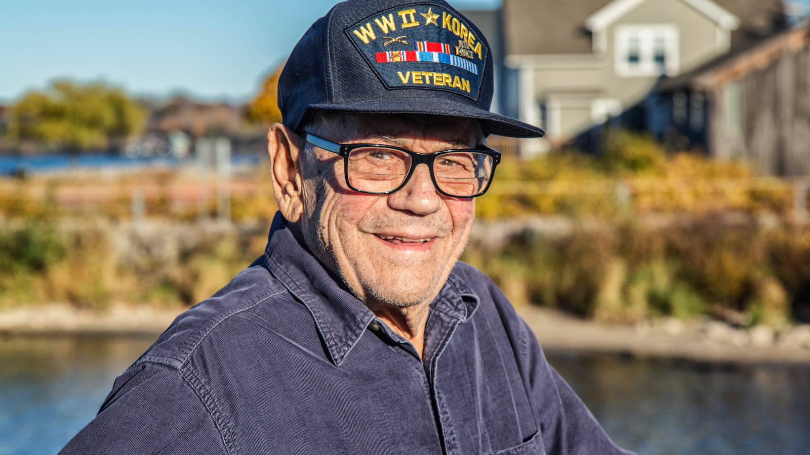 Elderly veteran smiles while wearing his hat