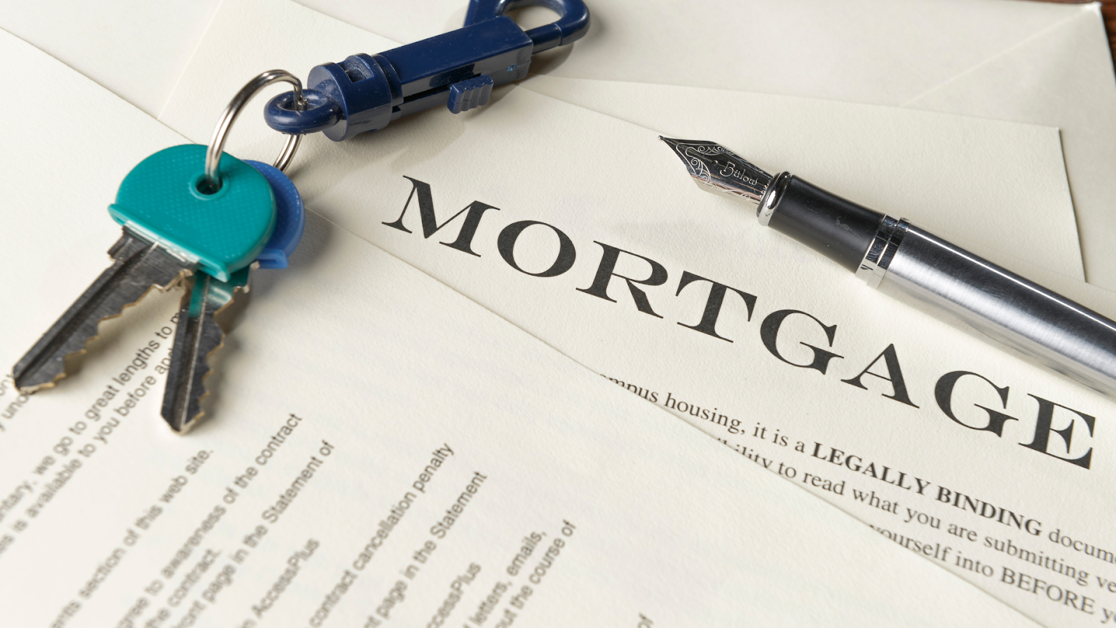 Mortgage documentation with keys and pen on it