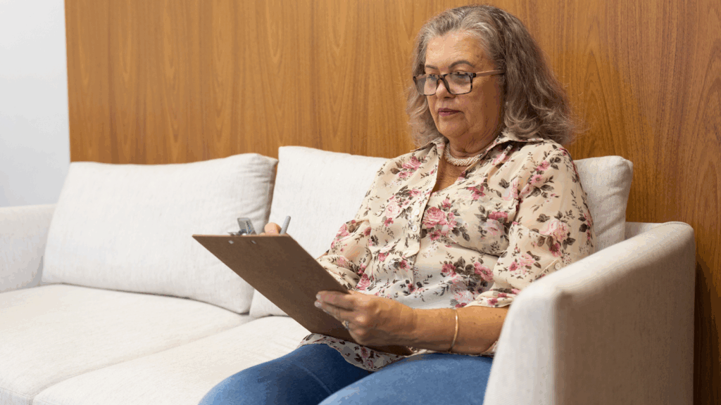 Old woman filling out forms for tax exemption