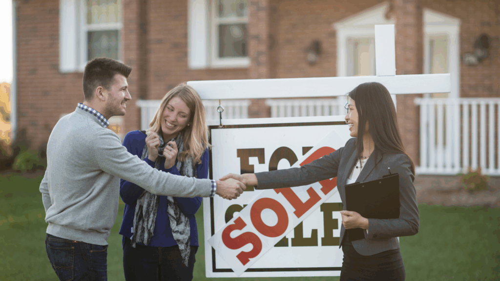 Real Estate agent congratulating couple on newly-bought property