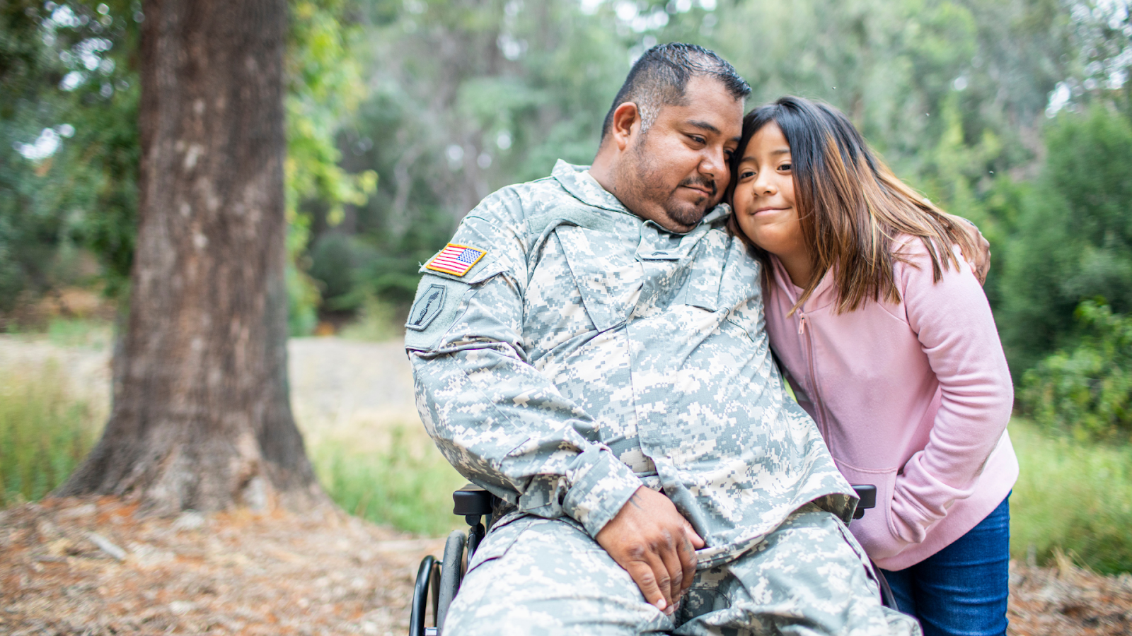 Disabled veteran embracing his daughter