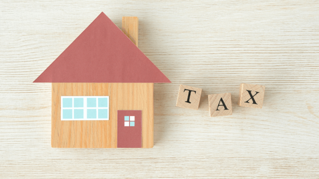 Personal property tax concept with wooden home and blocks