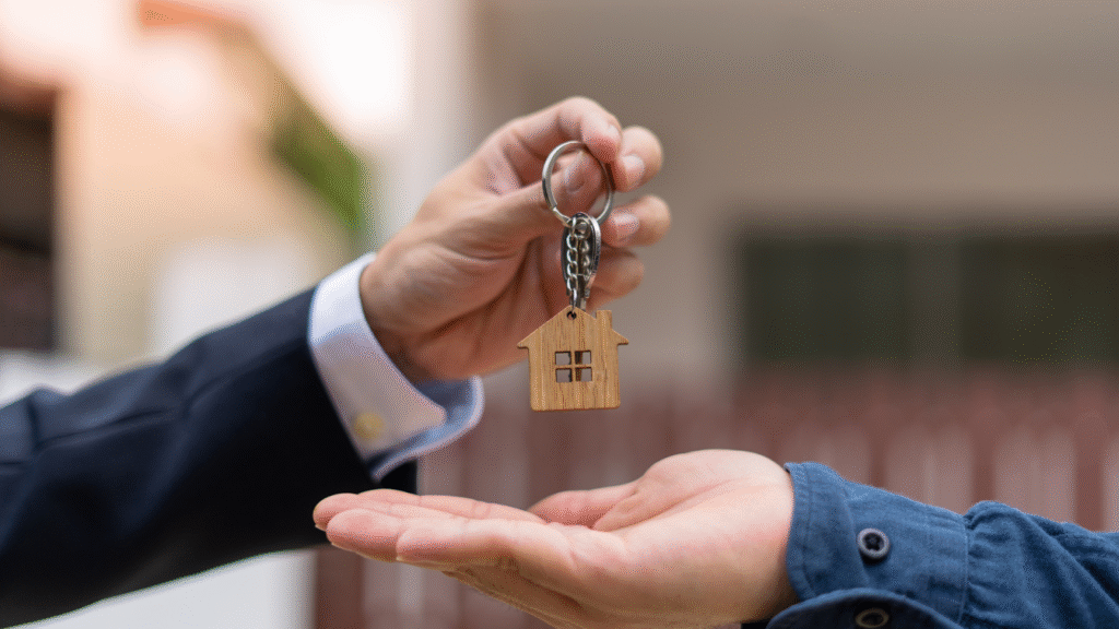 Giving the house key to the new homeowner