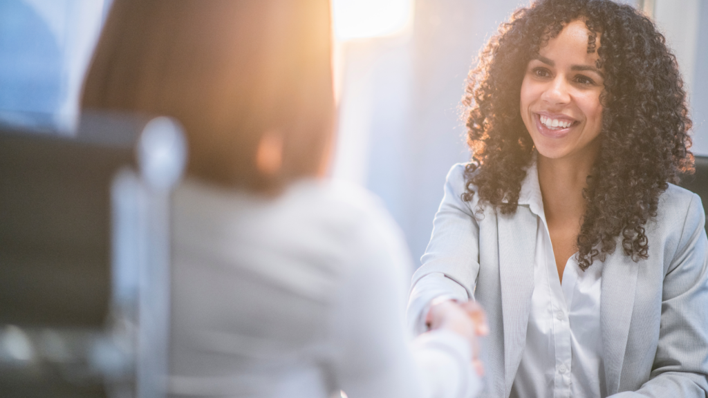 A consultant shaking hands with a homeowner seeking property tax assistance