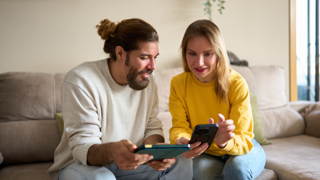 A couple reviewing comparable property data on their devices