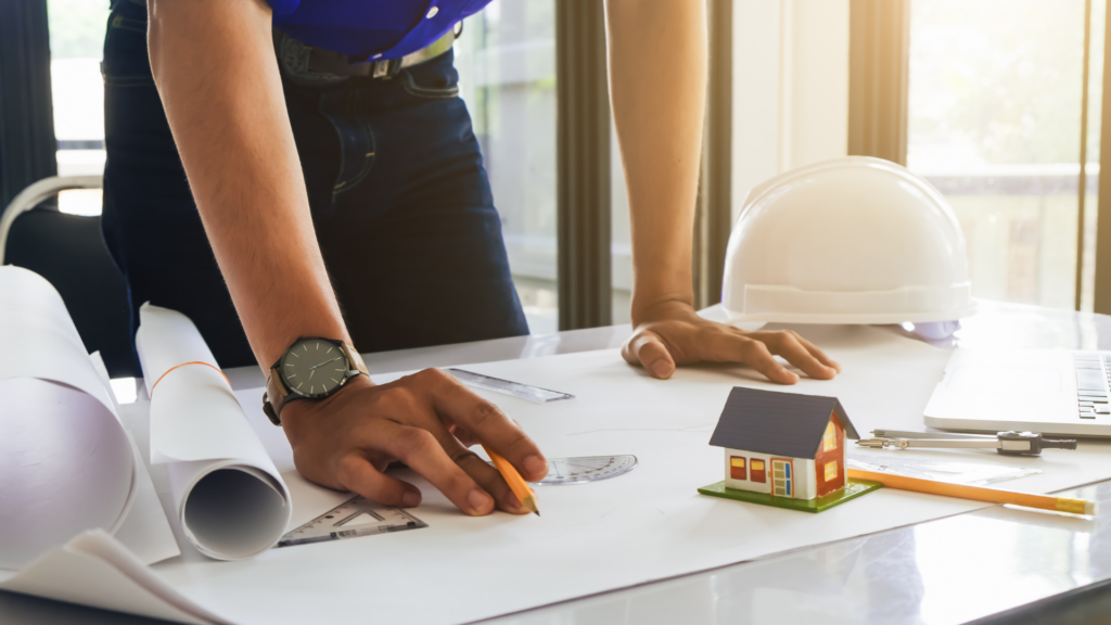 Construction professional reviewing blueprints before repurposing Houston property