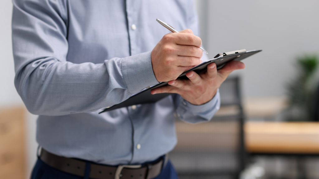 A professional appraiser writing notes during a commercial property assessment