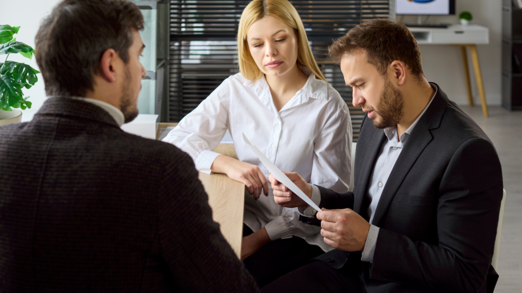 Business owners reviewing property tax assessment notice with a professional consultant