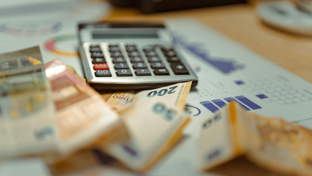 Calculator resting on paperwork showing accumulating tax penalties