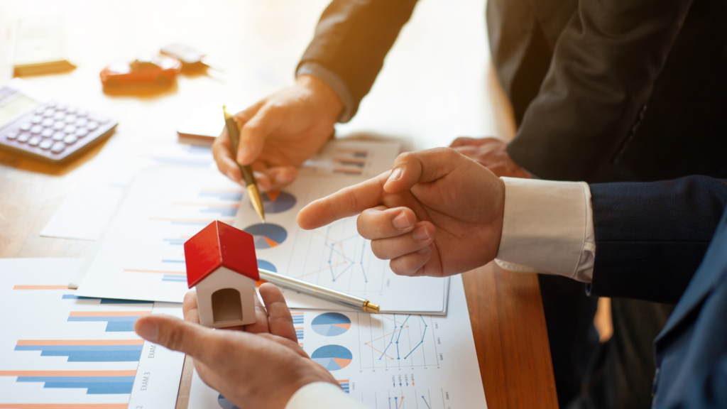 Consultants reviewing property valuation charts that misrepresent comparable home sales data