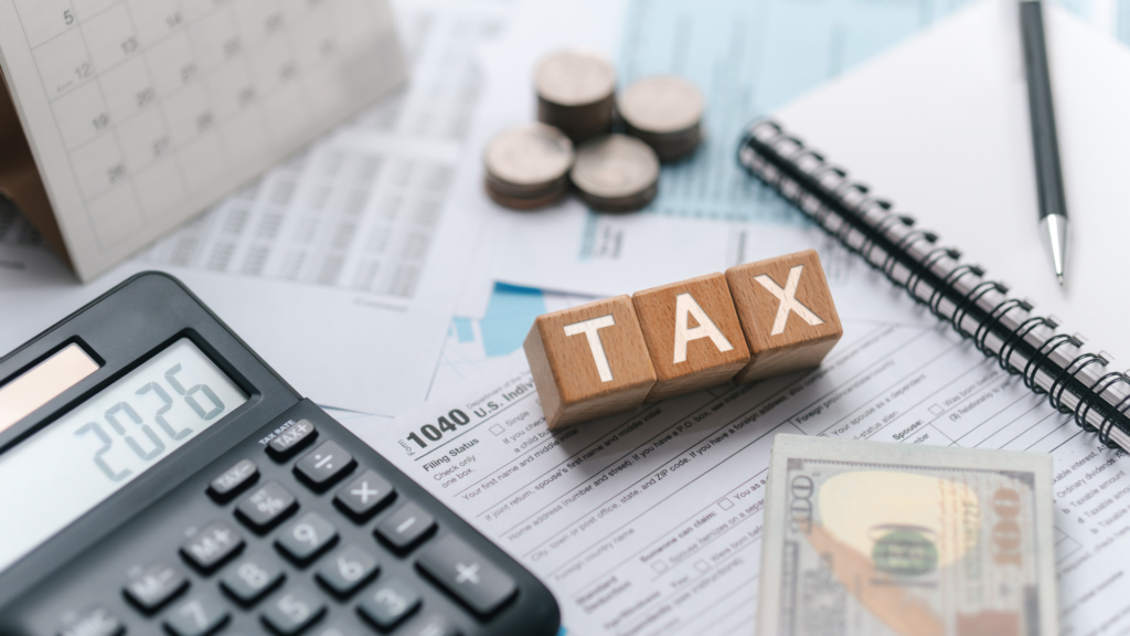 Desk setup showing tax calculation tools and financial documents