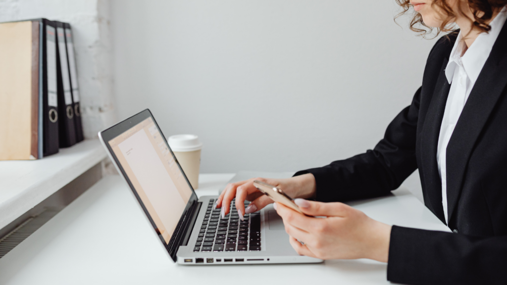 Homeowner following up with appraisal district using laptop and mobile phone