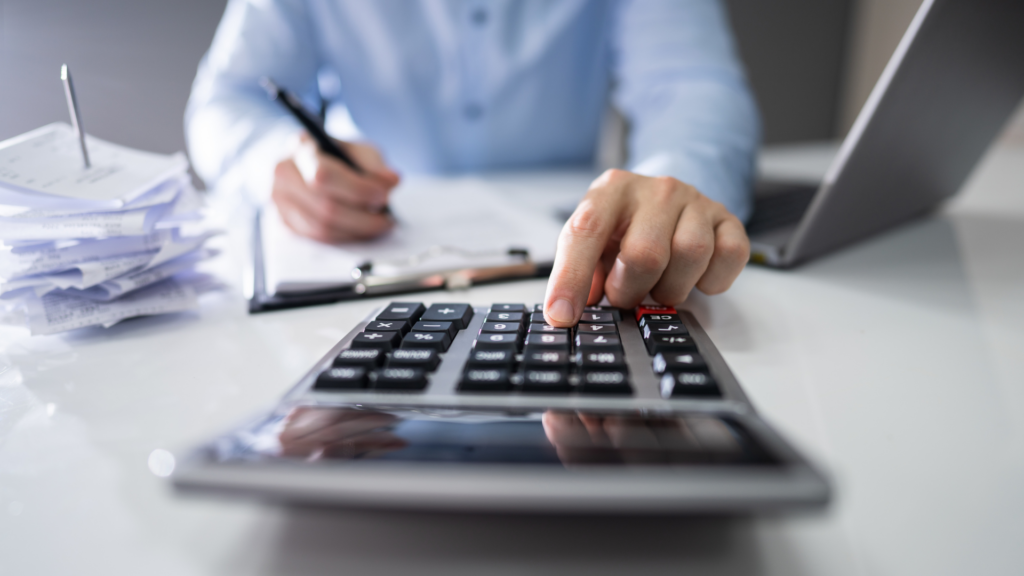 Professional reviewing accumulated tax documents and calculating long term property tax impact