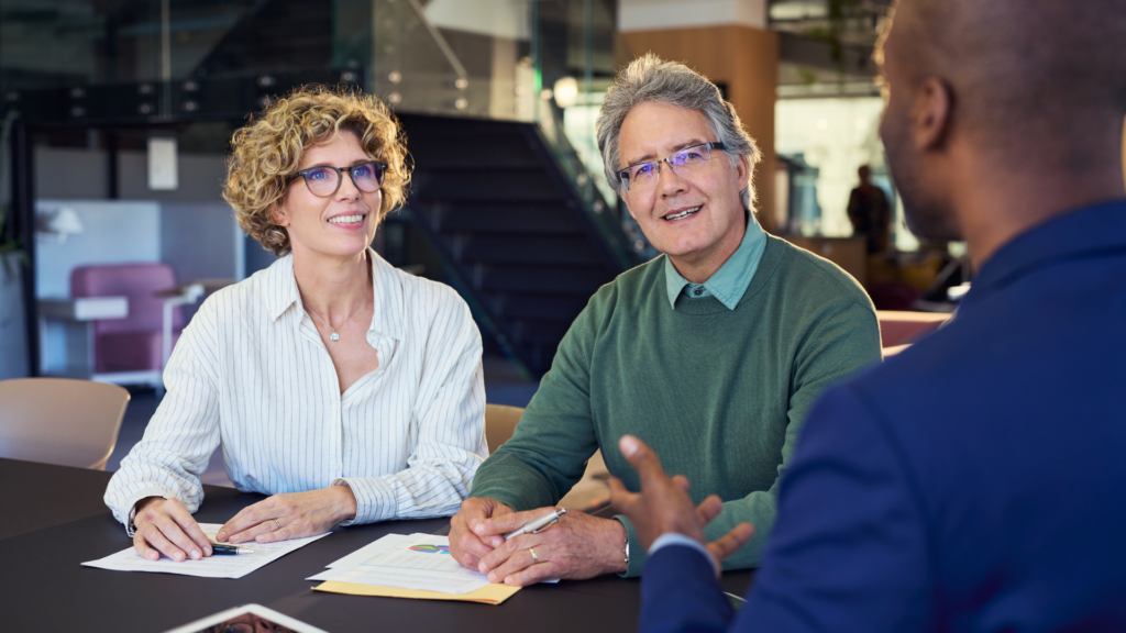 Senior homeowners in discussion with tax consultant about exemption benefits